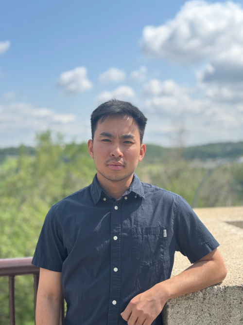 Picture of a man smiling outside in the summer time